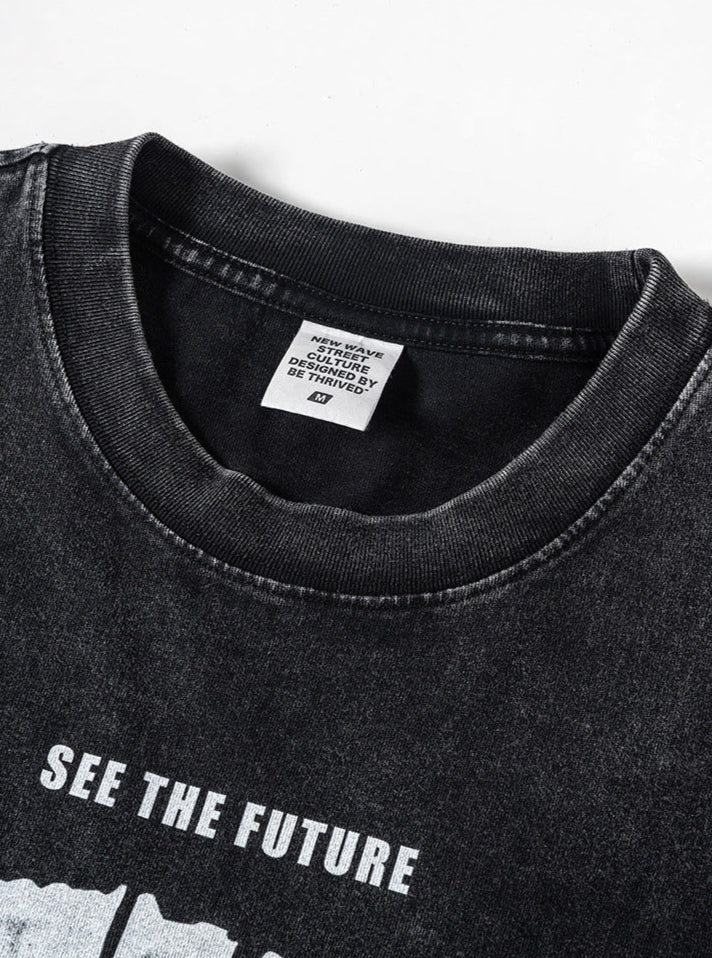 Close-up of collar and interior tag on black washed tee with streetwear branding.