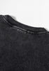 Back neckline detail on washed black tee with ribbed collar and fade effect.