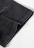 Folded sleeve hem detail on black tee with visible twin-needle stitching.