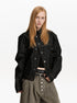 Close front view of stand collar jacket showing offset buttons and contrast stitching.
