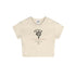 Beige cropped T-shirt featuring a black and red graphic print, laid flat against a white background