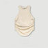 Off-white sleeveless top with ruched sides and curved hem, flat product shot
