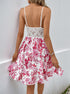 Back view of white floral sundress with lace panel and adjustable straps.