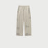 Light beige drawstring pants displayed flat with side pockets and textured wash pattern. Shows relaxed straight-leg silhouette