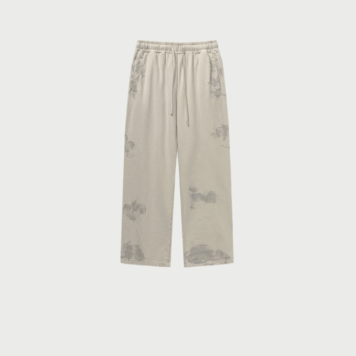 Light beige drawstring pants displayed flat with side pockets and textured wash pattern. Shows relaxed straight-leg silhouette