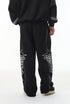 Back view—black baggy sweatpants with straight leg and stacked hem.