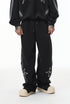 Black baggy sweatpants, wide-leg straight hem, mid-rise drawstring, front view.