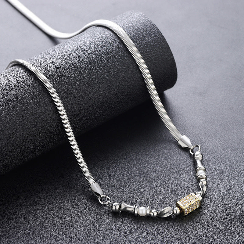 Silver necklace with mixed beads and gold accent displayed on black roll.