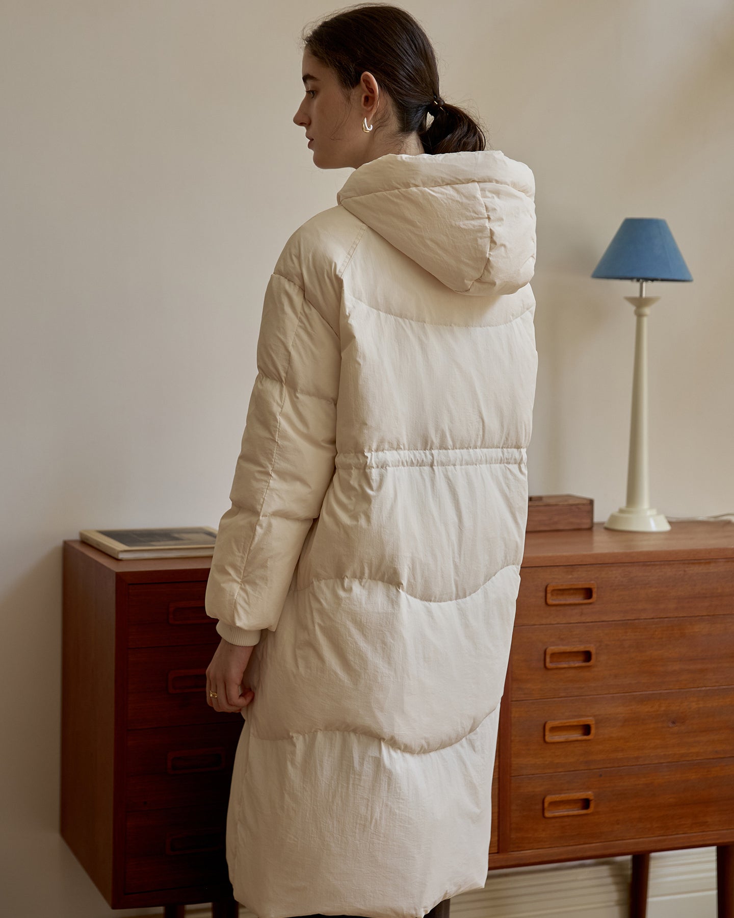 Long hooded beige puffer coat for women back design