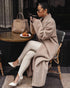 Beige long teddy coat, café seating, soft winter layering