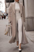 Beige long teddy coat over ribbed knit dress, city street