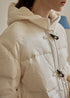 Toggle button and fabric detail of beige puffer coat
