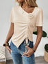Beige ruched top with drawstring front and floral accent