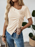 Beige ruched blouse with rose detail and short sleeves