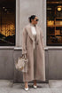 Beige teddy lapel coat, hands in pockets, front street view