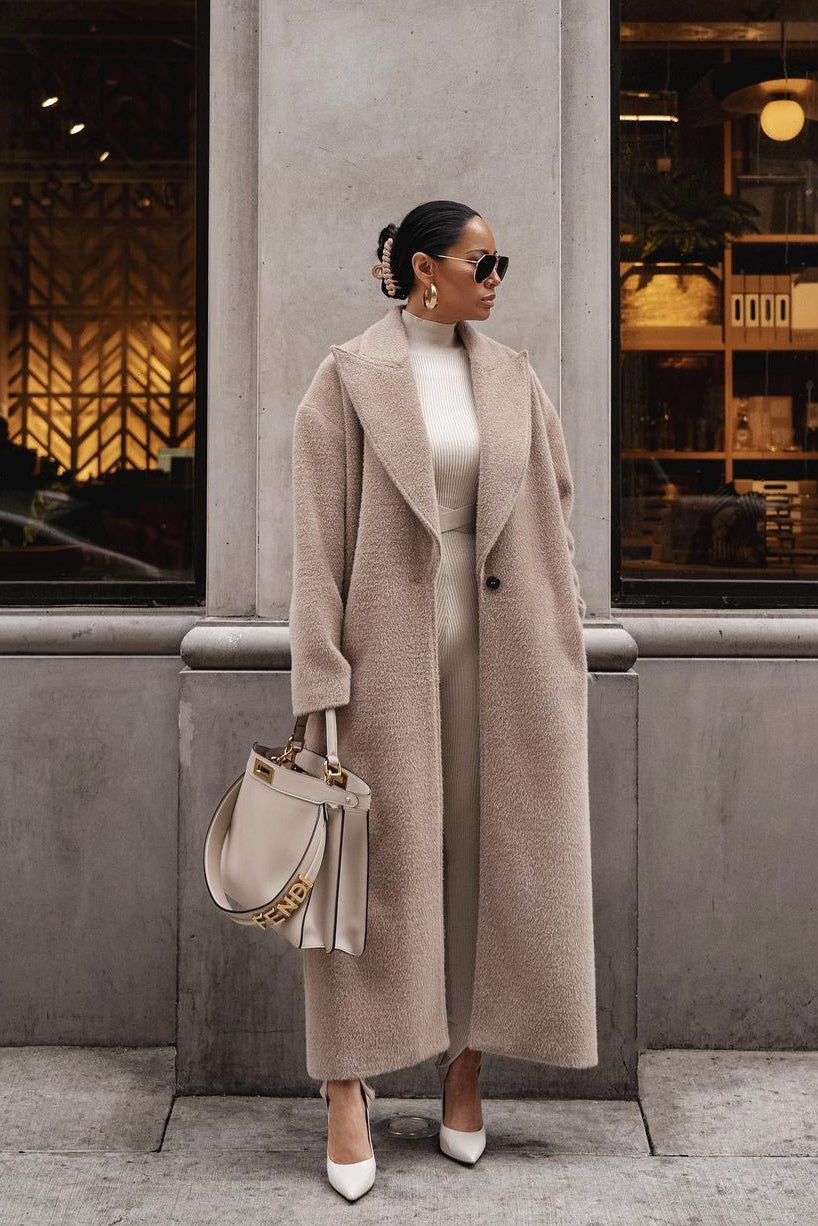 Beige teddy lapel coat, hands in pockets, front street view