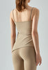 Back view of beige cooling tank top with fitted design and thin straps.