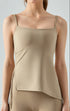 Woman wearing beige cooling tank top with drawstring side detail.