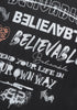 Angled view of layered 'Believable' typography and street-style slogans on black tee.