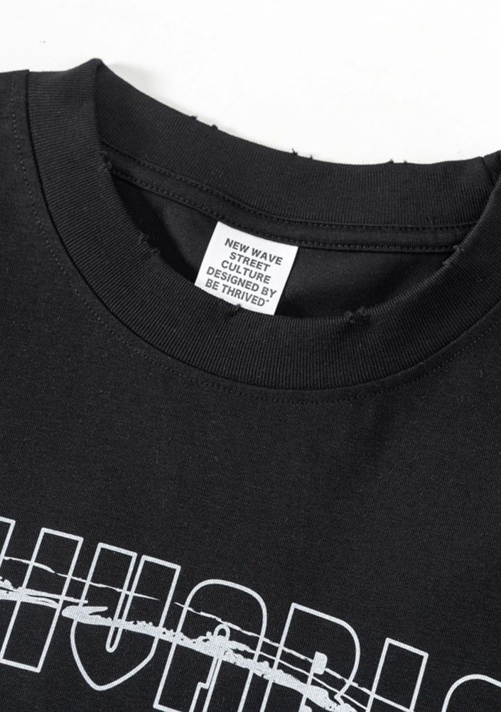 Close-up of black graphic tee collar with visible label and upper chest print.