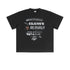 Black oversized T-shirt laid flat with multi-font 'Believable' graphics and creative symbols.