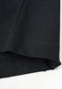 Bottom hem of black T-shirt showing clean, reinforced stitching.