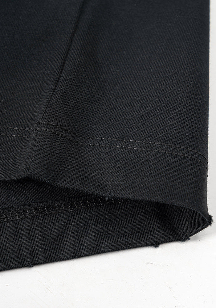 Bottom hem of black T-shirt showing clean, reinforced stitching.