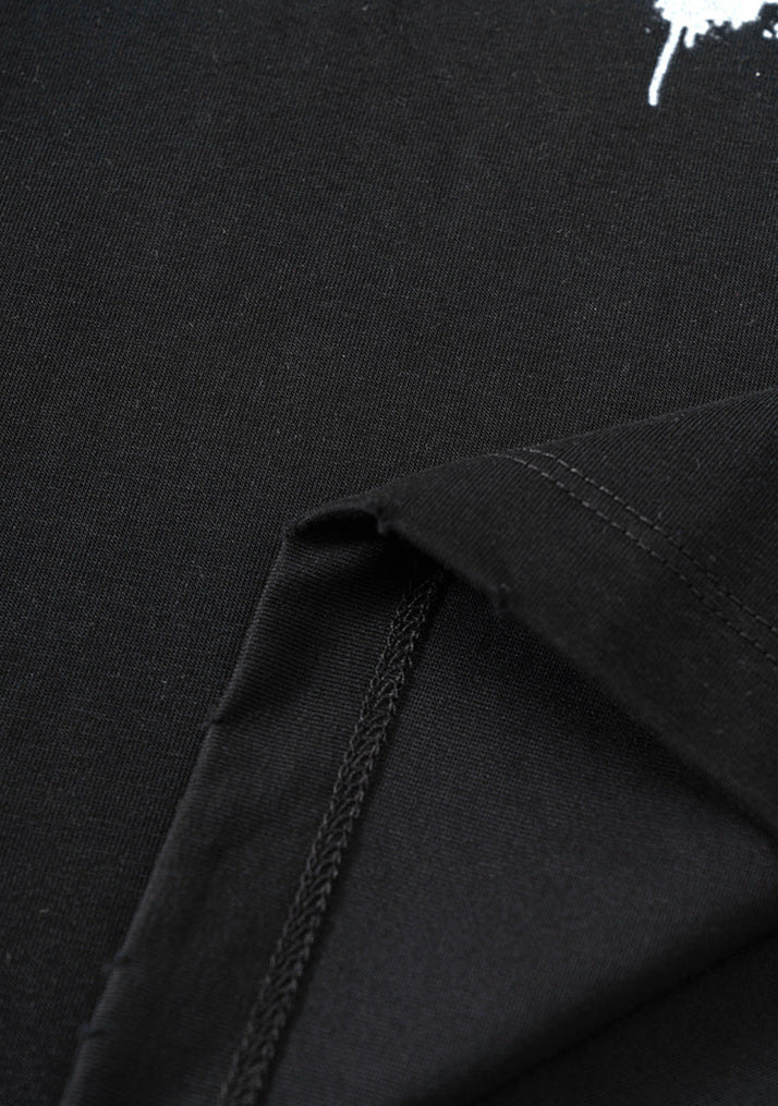 Interior stitching detail on black T-shirt hem showing construction quality.