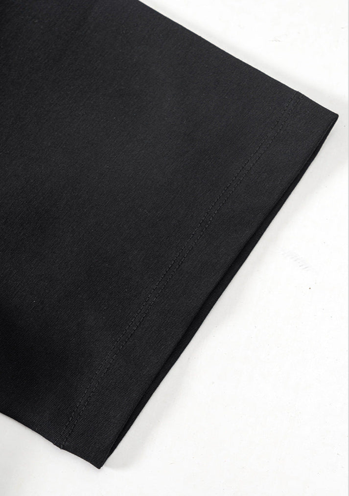 Close-up of black T-shirt sleeve hem with neat stitching detail.