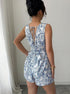Back of casual sleeveless romper in floral pattern