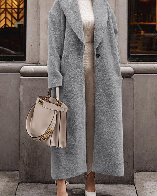 Woman in long gray teddy lapel coat, slim fit—best winter coats street look