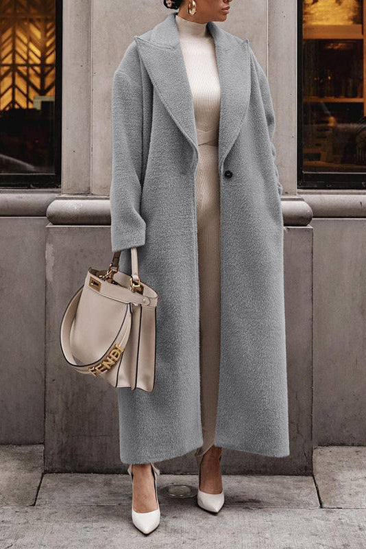 Woman in long gray teddy lapel coat, slim fit—best winter coats street look