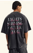Model showing rear view of black T-shirt with inspirational slogan in mixed fonts.