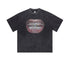 Black graphic T-shirt laid flat with hyper-detailed mouth and jeweled teeth design.