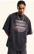 Close-up of black T-shirt featuring detailed grillz illustration and bold lips.