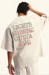 Back of off-white tee with layered street-style typography reading 'Lights Shining Outta You.
