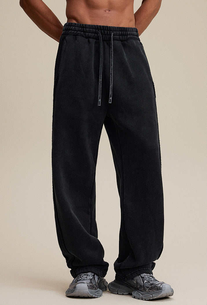 Black baggy sweatpants, relaxed front angle on model