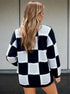 back view of black checkered mock neck sweater with loose fit