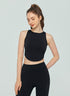 Woman wearing black sleeveless crop top and high-waisted leggings, front view.