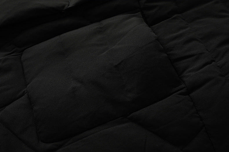 Quilted pocket detail on black long puffer coat