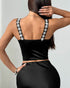 Back view of black satin corset top with rhinestone floral straps and fitted silhouette.
