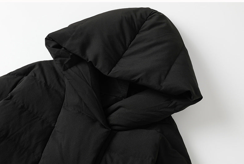Close-up of black hooded oversized down coat collar detail