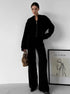 Woman wearing black knit lounge set with zip jacket and pants