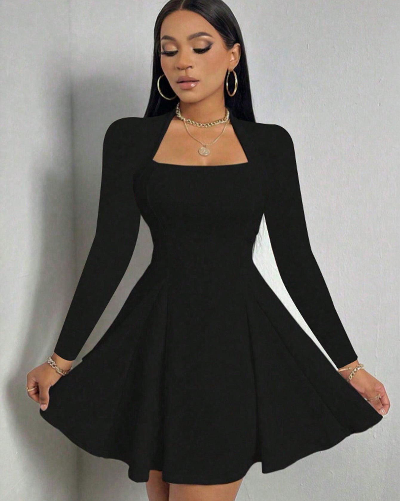 Black long sleeve dress with square neckline and flared A-line hem shown in elegant front pose.