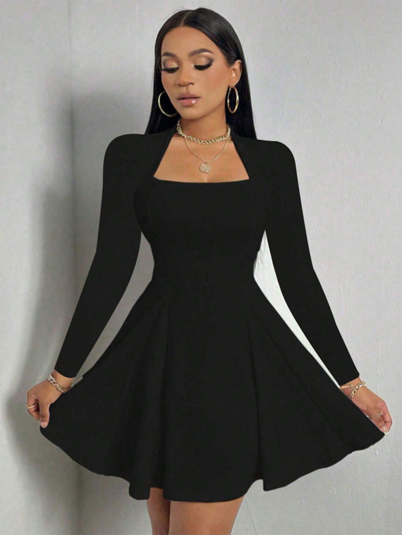 Black long sleeve dress with square neckline and flared A-line hem shown in elegant front pose.