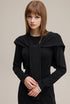 Close-up of black long sleeve bodycon dress with shawl, ribbed knit and tie front