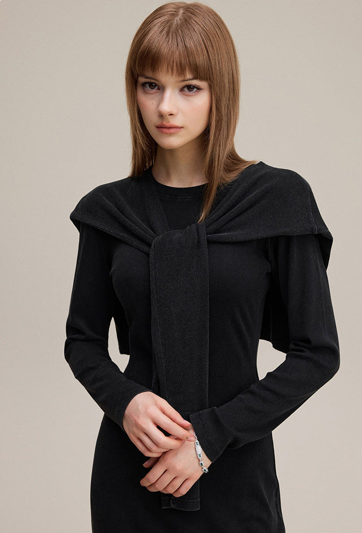 Close-up of black long sleeve bodycon dress with shawl, ribbed knit and tie front
