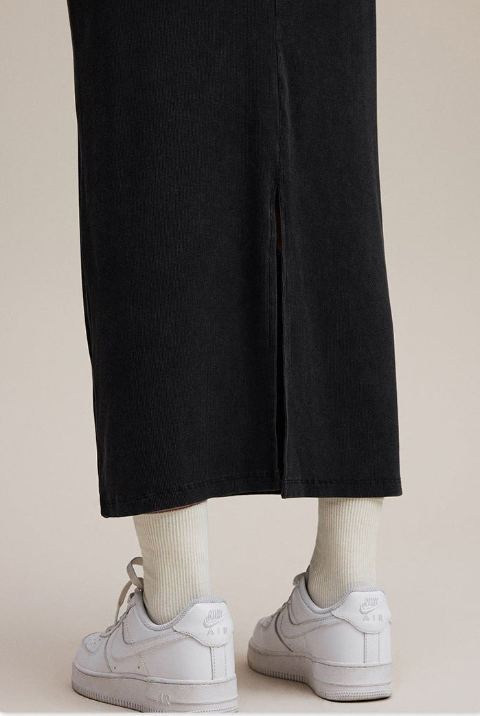 Black long sleeve bodycon maxi dress, back hem slit detail with sneakers