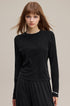 Model wearing black long sleeve tee with slim raglan fit front view