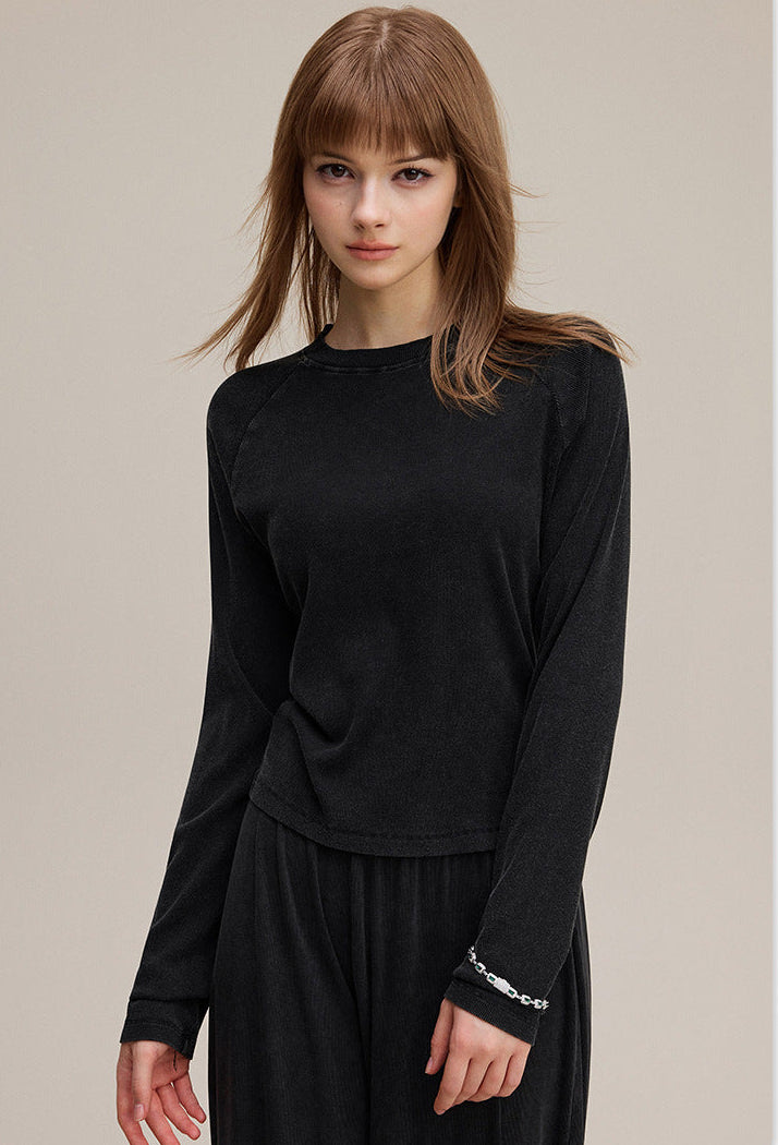 Side view of black slim fit long sleeve tee with ribbed cuff detail